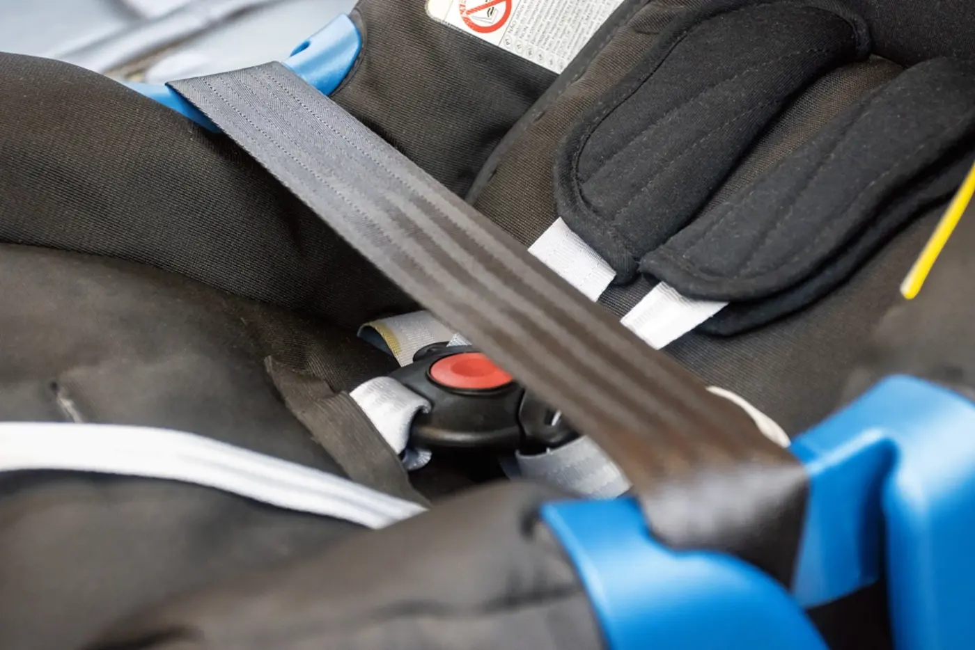 Närbild på säkerhetsbältet på ett babyskydd.